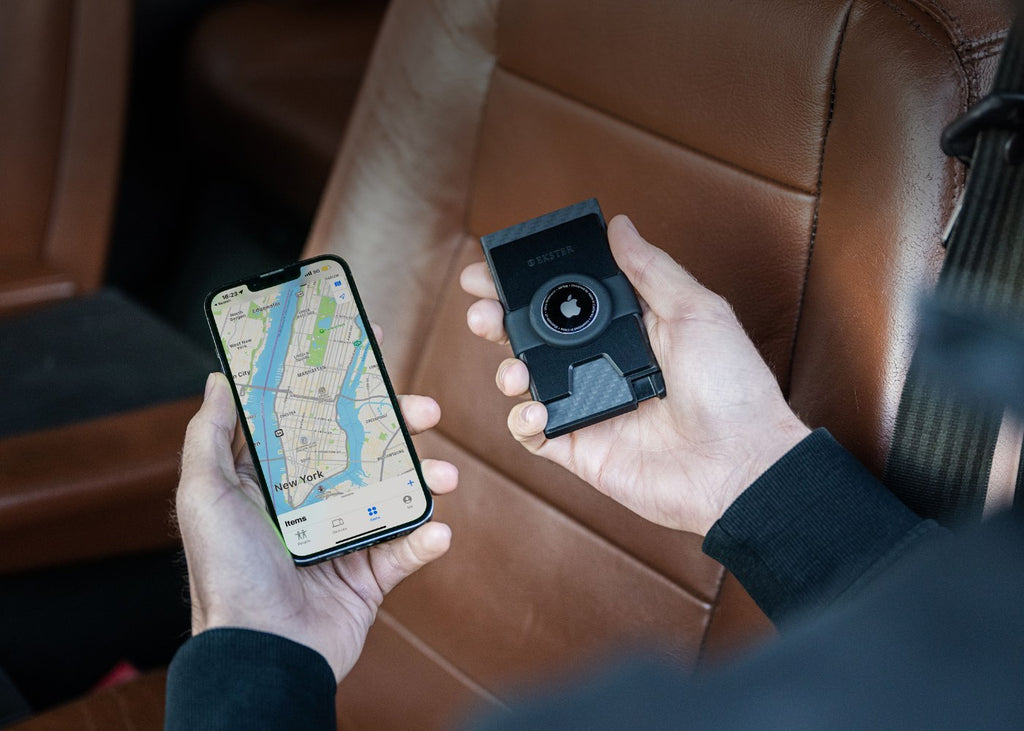 man's hands holding iphone and ekster cardholder for airtag