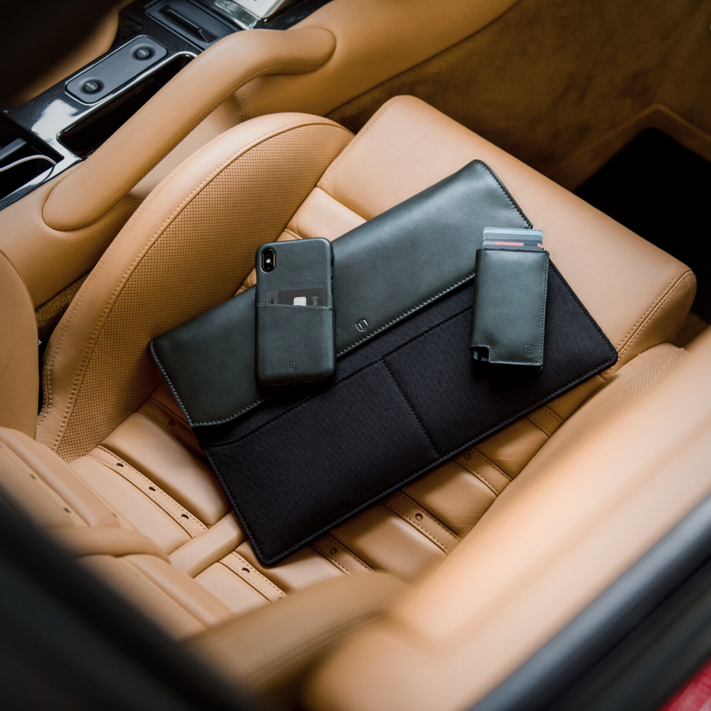 Ekster’s laptop case, Parliament wallet and iPhone on a luxury leather car seat.
