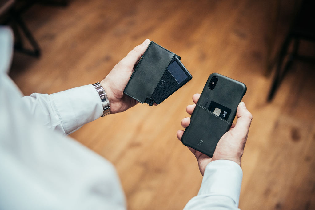 Man holding his phone and a card wallet