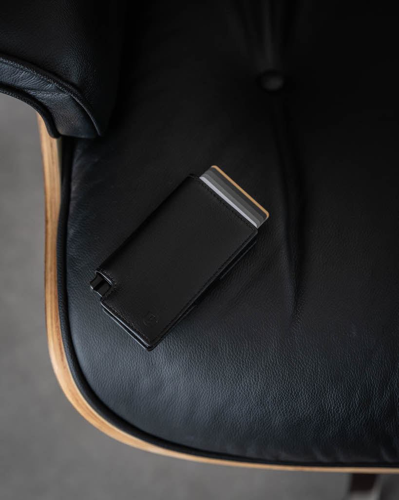 black leather wallet lying on a chair