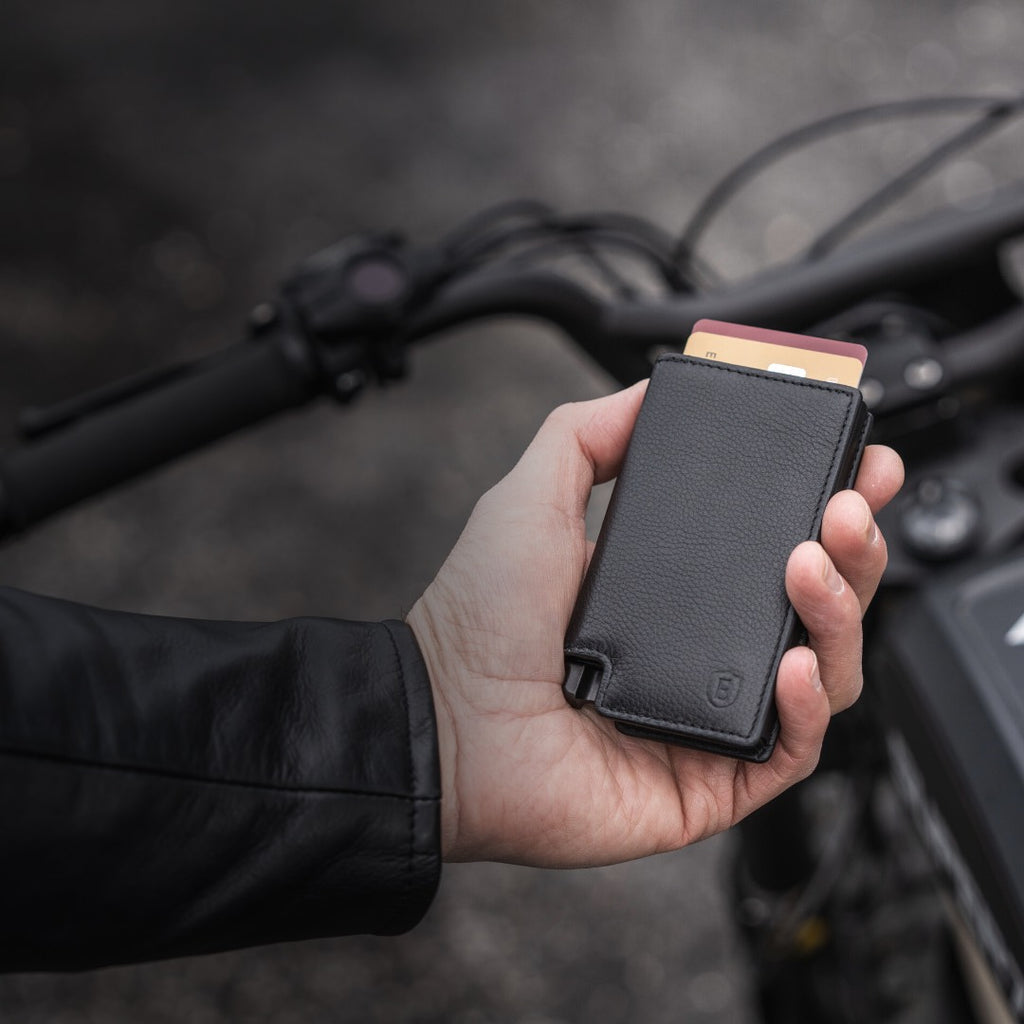 man holding black leather wallet