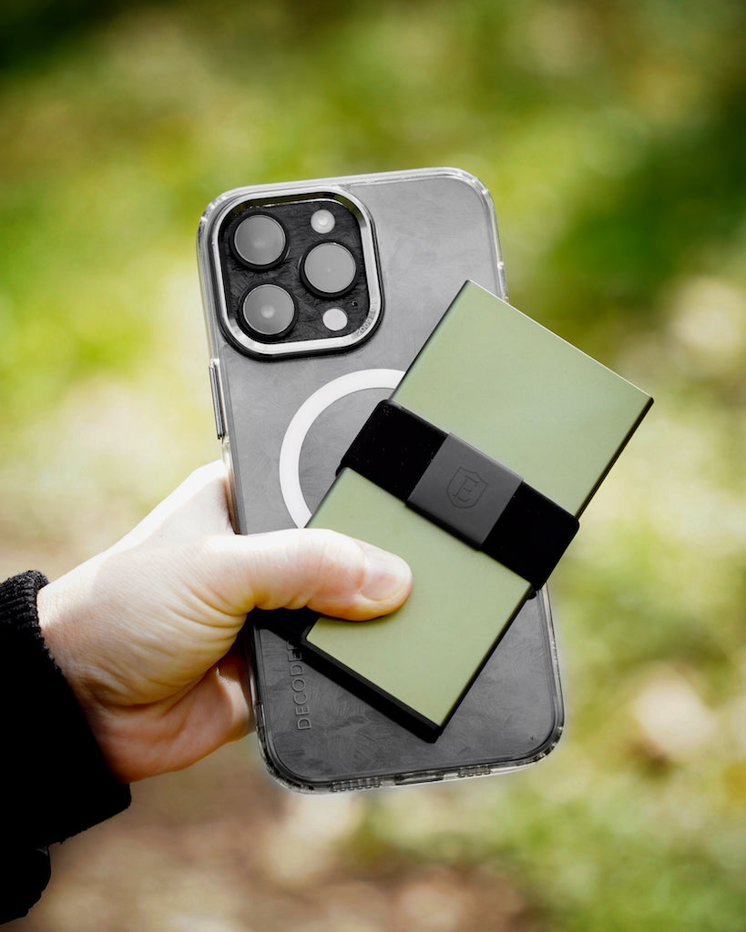 man holding phone and green aluminum wallet