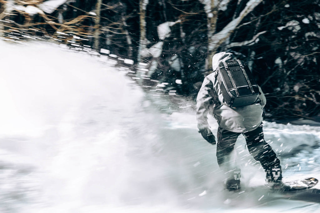 man snowboarding at night