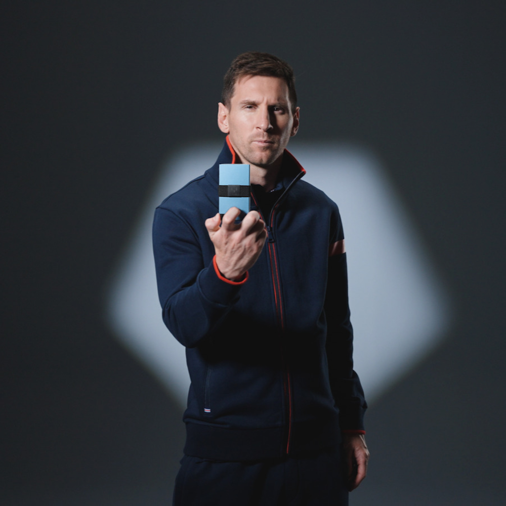 Lionel Messi holding the Messi Wallet in front of him. 
