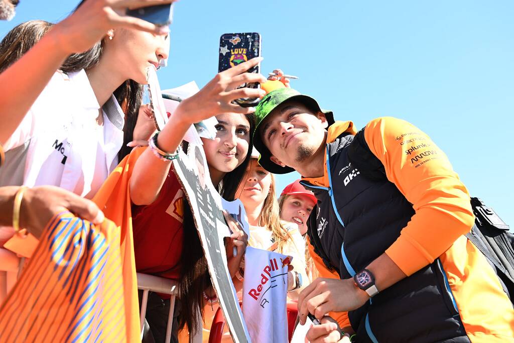 Lando Norris taking a picture with a fan