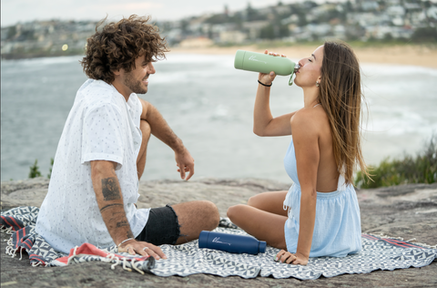 Chilling by the beach with The Jackie Family Towel and Blem Reusable Bottles