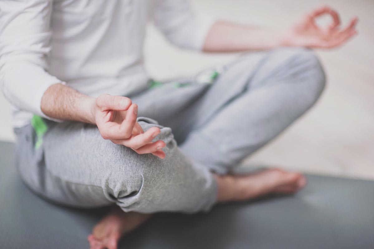Man sitting cross legged meditating