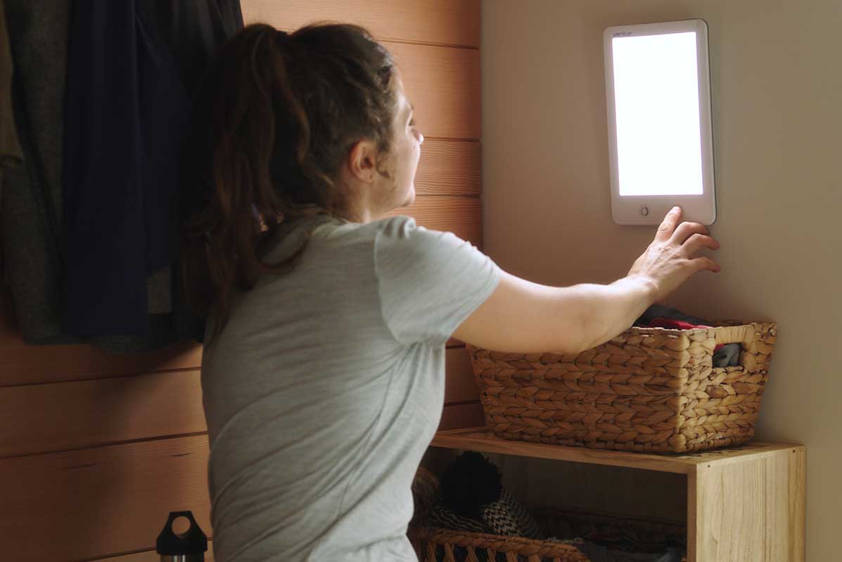 Woman adjusting brightness on Happylight