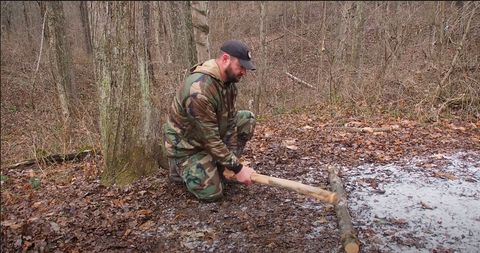 View of camp axe and cup of tea in a forest. Bush craft concept