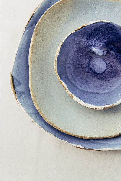 Hana Karim Ceramics handmade tableware, colorful plates, minimal table setting, blue tabletop inspiration