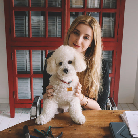 founder lauren brokaw with small white dog