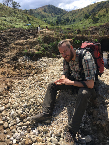 Wim leisurely sitting in a gem bearing dried up river bed 