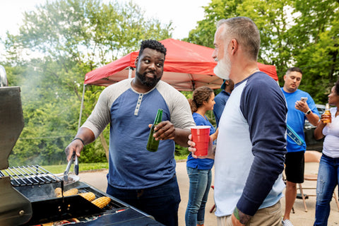 grilling-corn-while-holding-a-drink