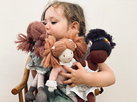 girl holding thread bear rag dolls