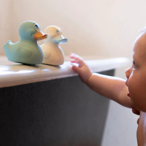 baby playing with natural rubber ducks