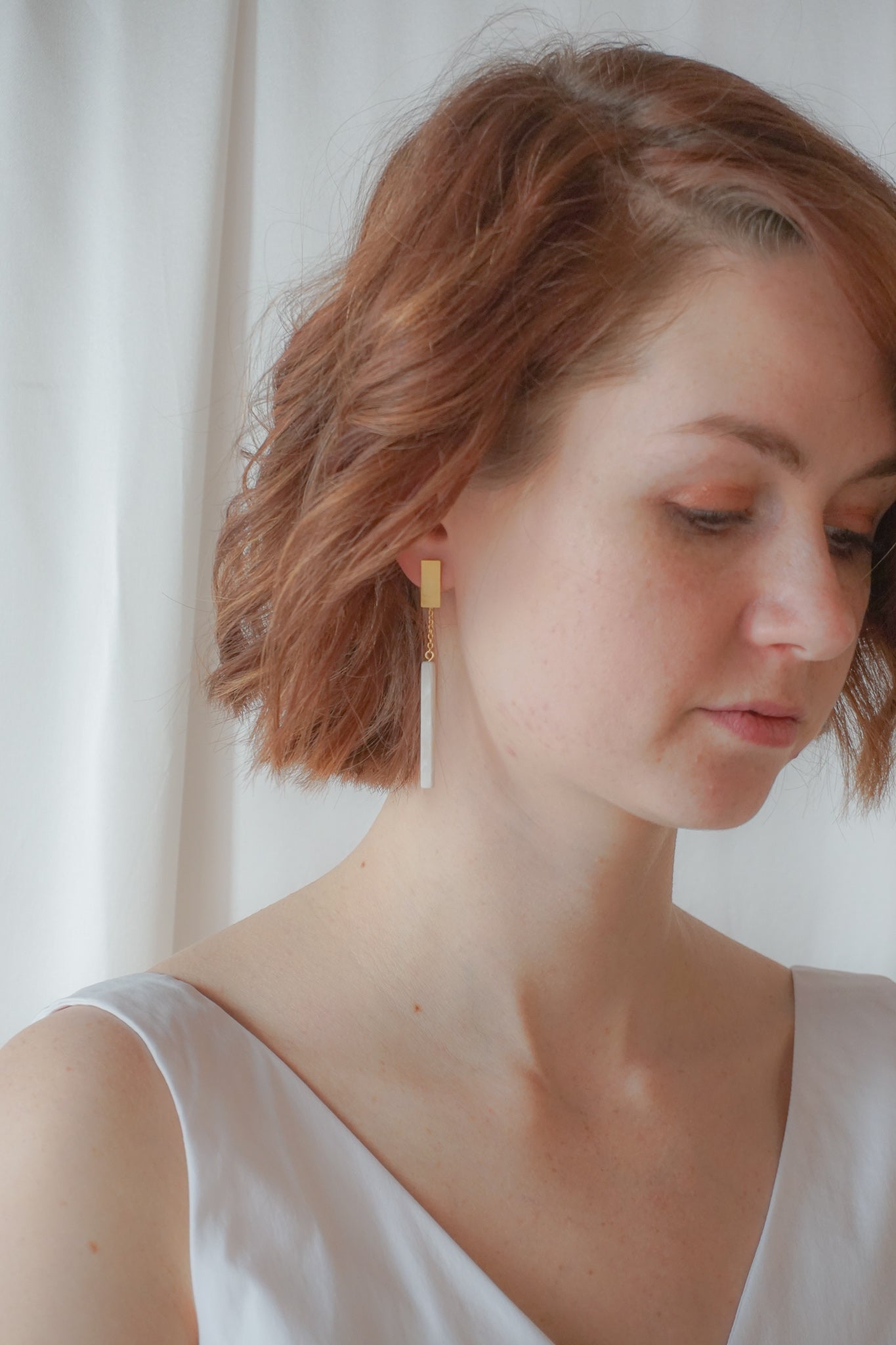 long earrings featuring a white rectangular stone