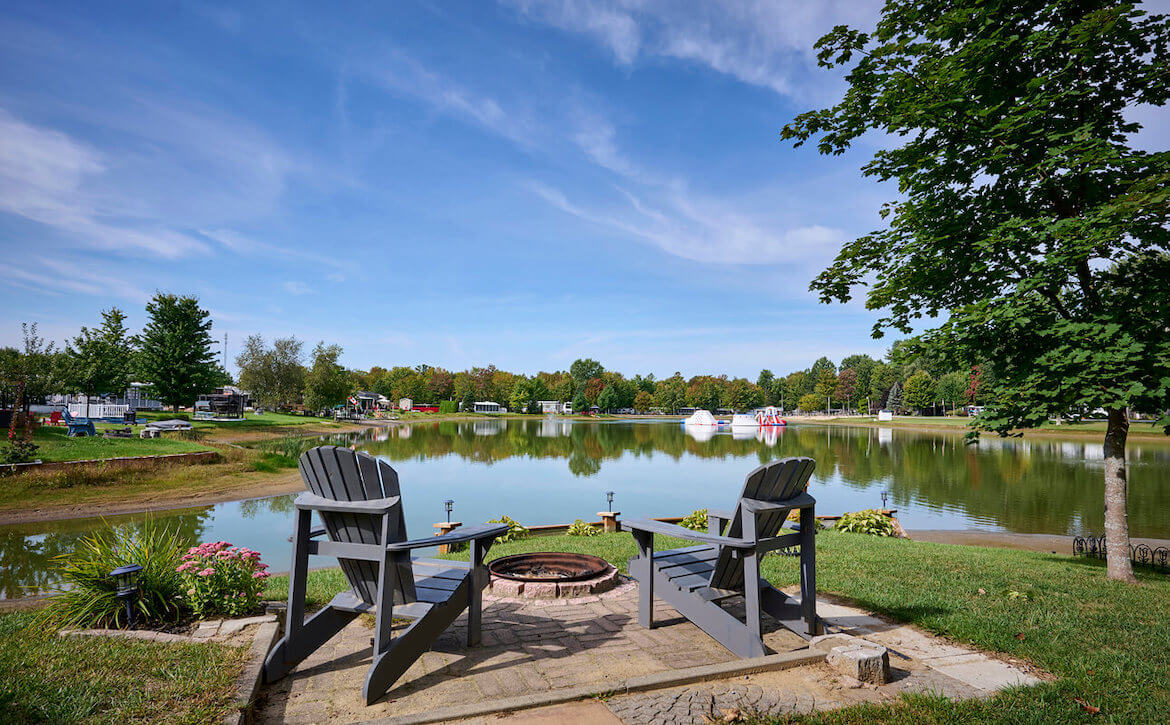 2 chairs in front of a lake at Kittawa campground on a sunny day