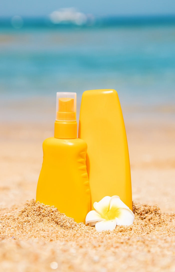sunscreen container on a beach