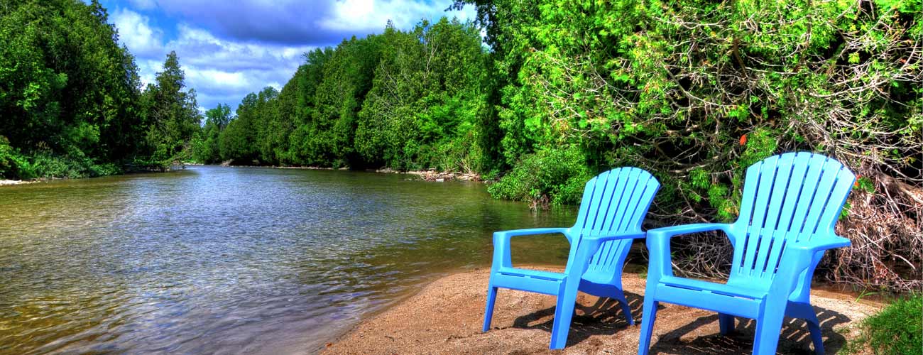 2 chairs set up by the pond in the Ontario Nature Preserve at Saugeen Springs Campground