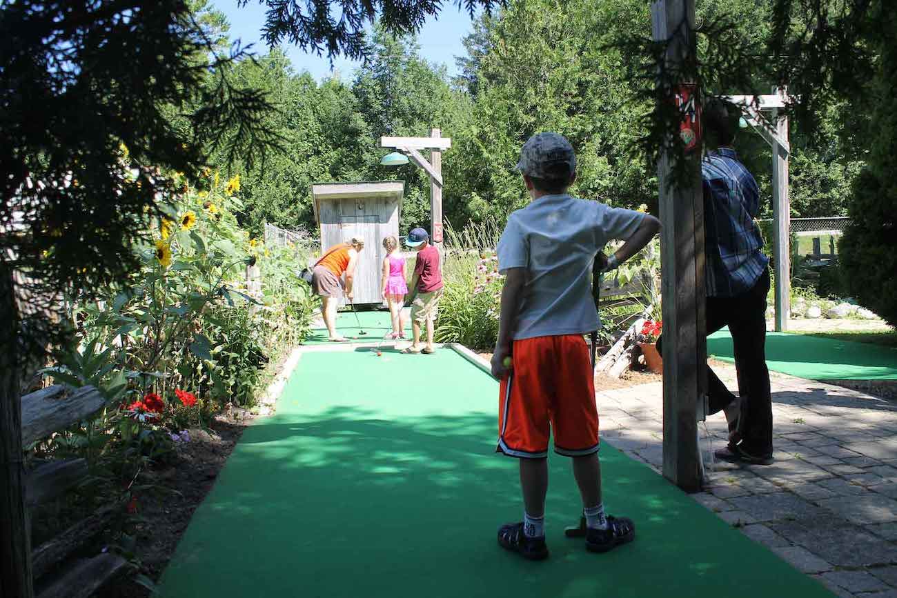 family playing mini-golf at Country Gardens RV Campground