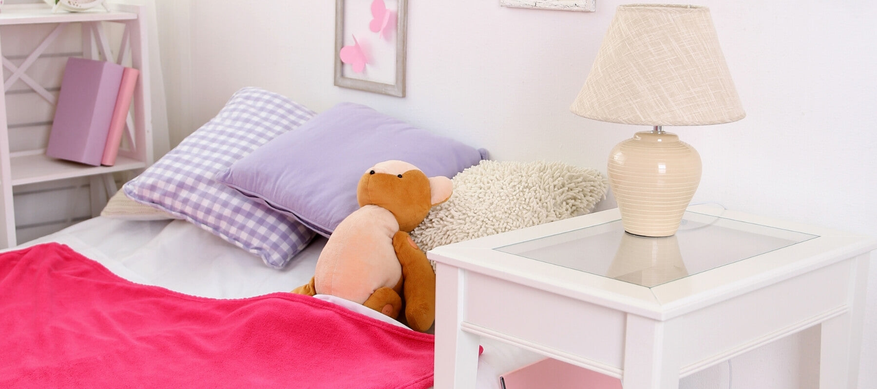 A nightstand next to a child's bed