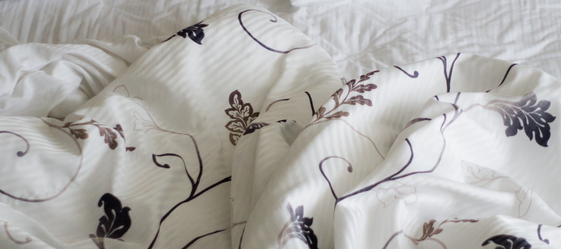 Close up of a white comforter made of flower pattern