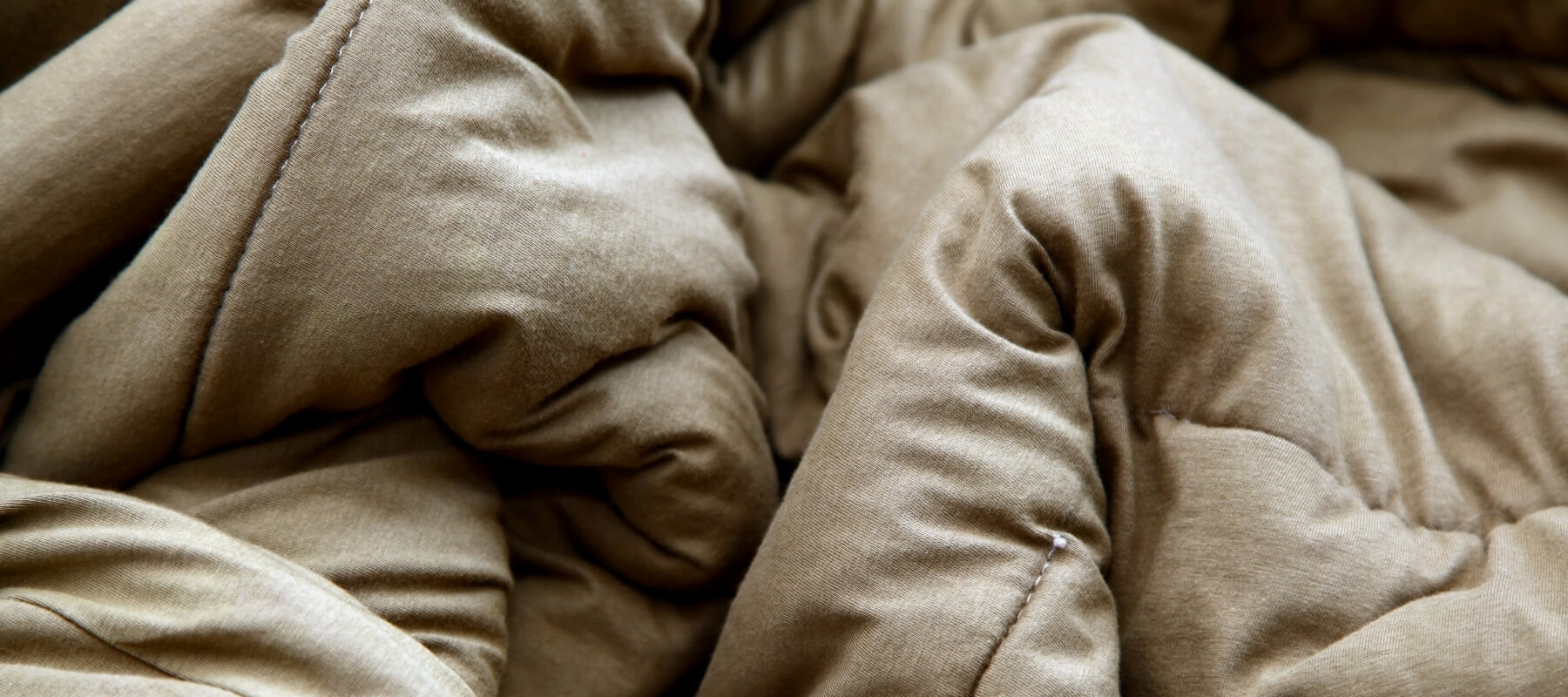 A close up of a brown duvet