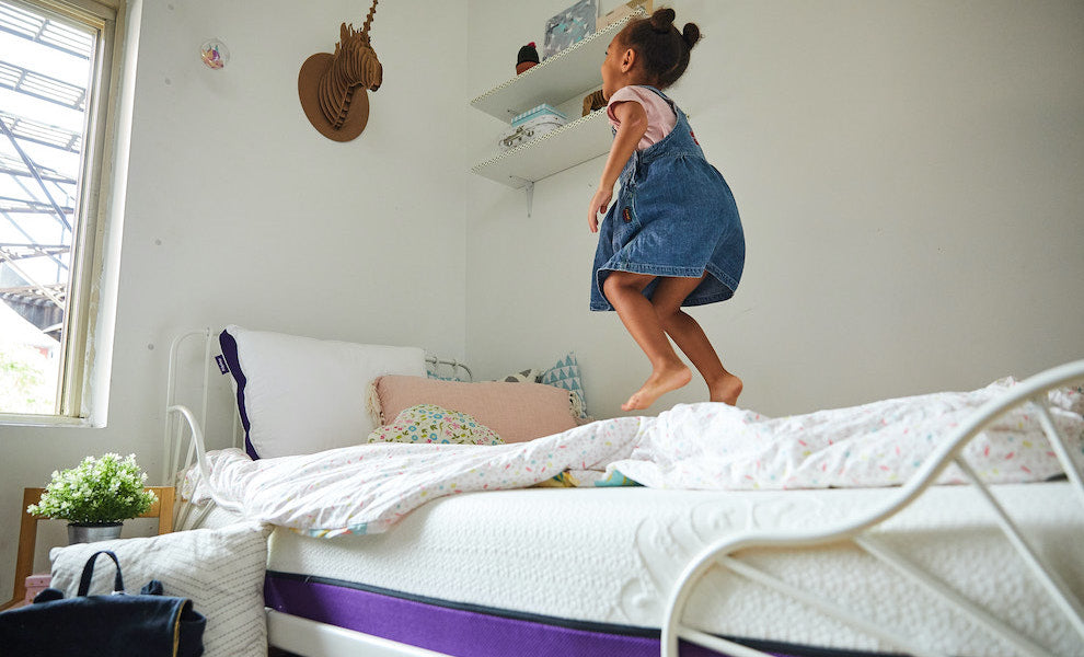 Little girl jumping on her Polysleep foam mattress.