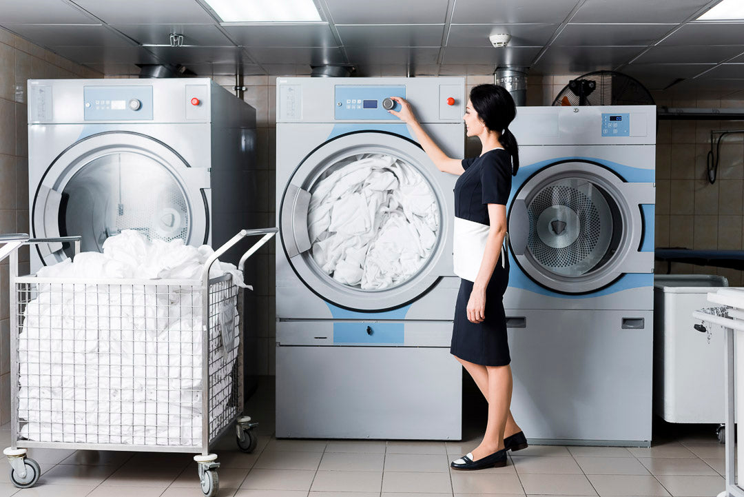 a maid inside of the hotel's laundry room