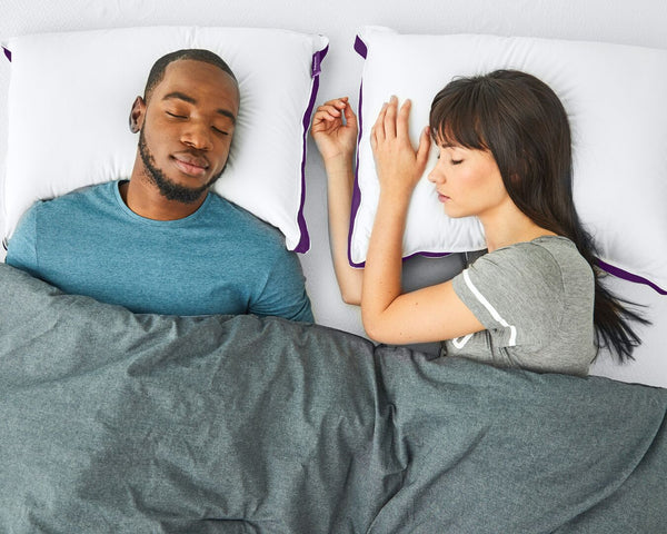 Couple napping in bed with the Polysleep pillow