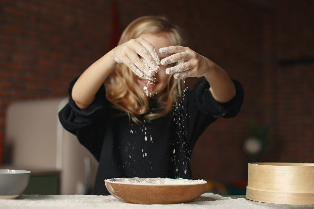 Little girl making breakfast for her parents