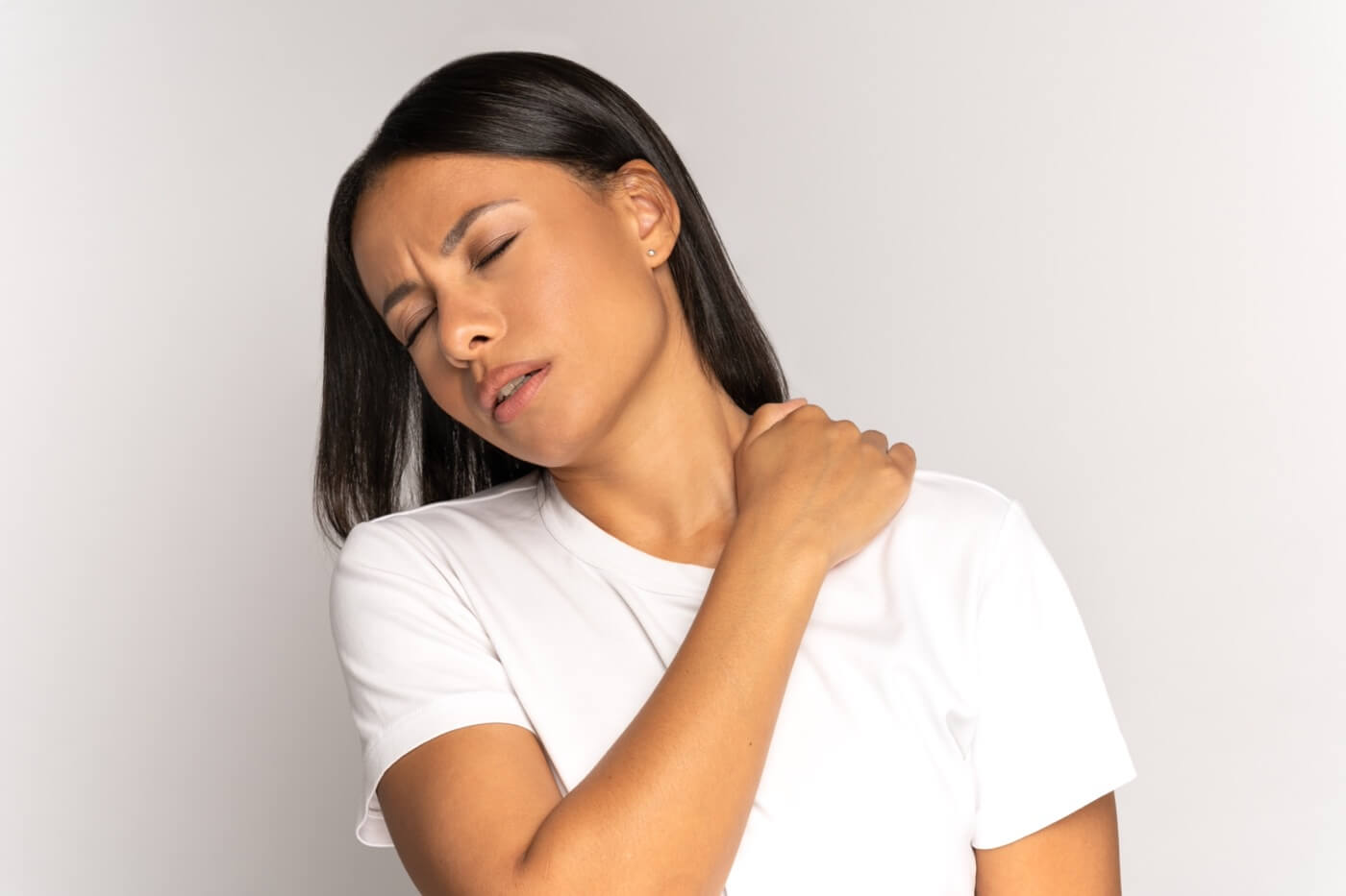 Woman with intercostal muscle strain massaging her neck