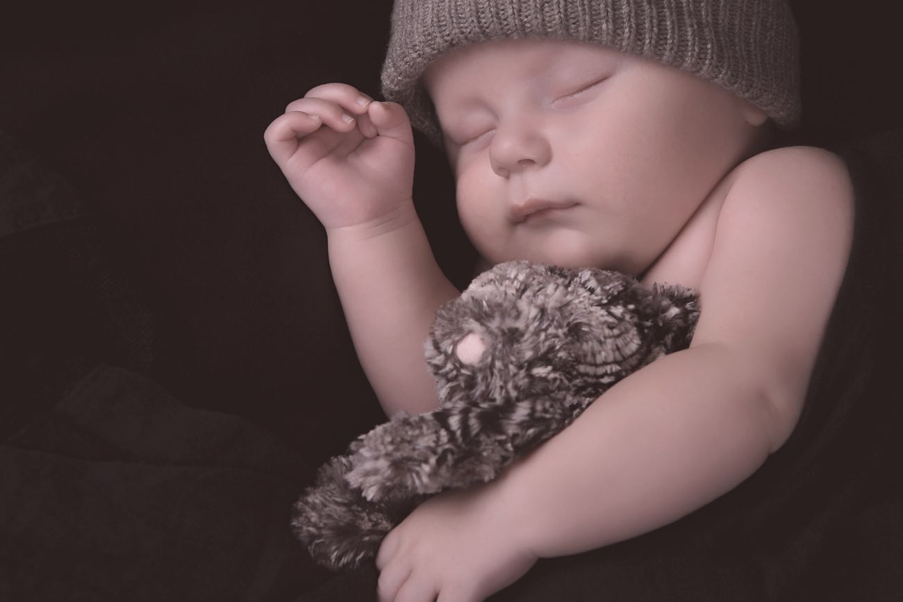 Studio shot of a tired newborn baby sleeping.