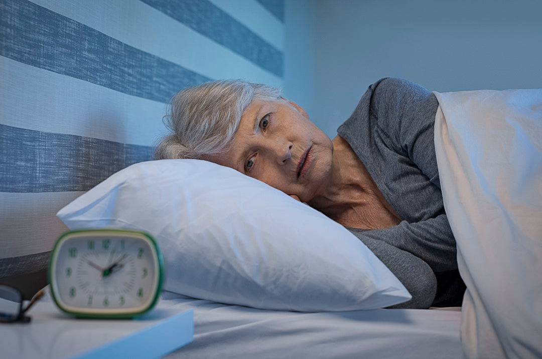 a elderly woman in bed unable to fall asleep