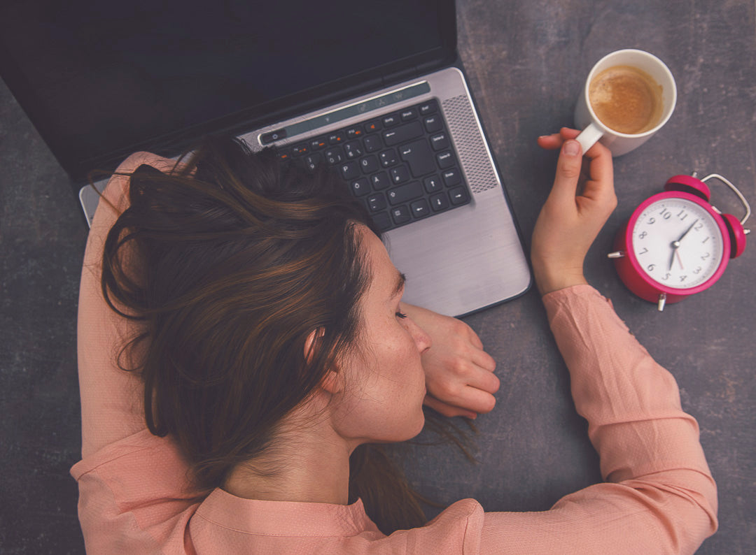 a woman asleep in front of her computer