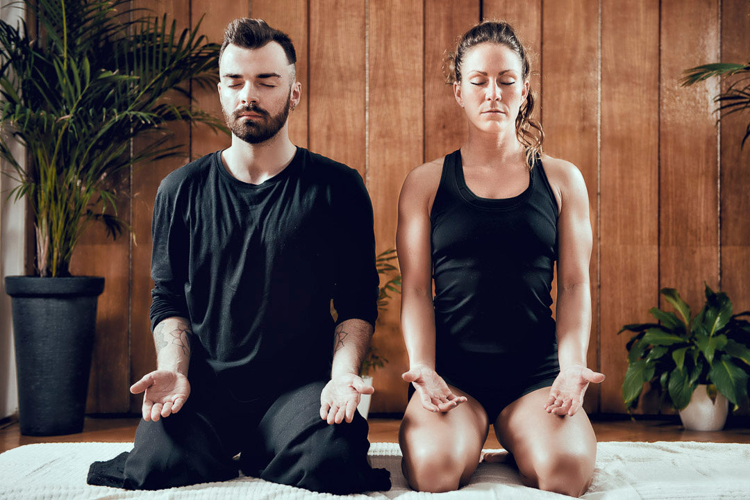 a young couple meditating