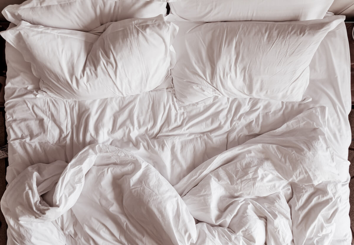 Top view of white sheets and pillows