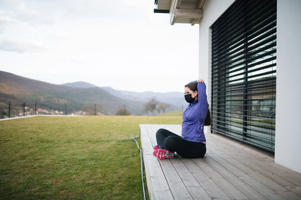 Woman stretching outside at home, Corona virus and quarantine concept