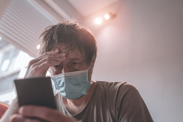 worried man using mobile phone in home quarantine