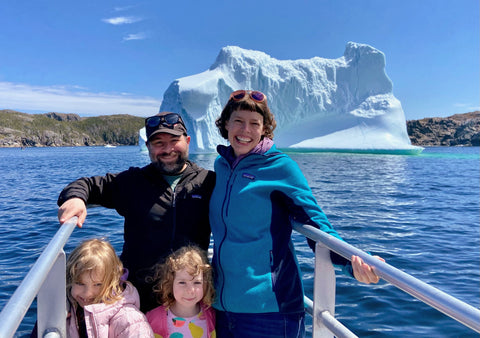 Family posing with an iceberg in Newfoundland 