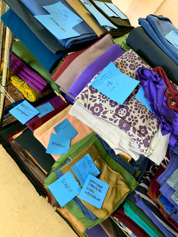 piles of hand-printed fabrics with messy post-it notes