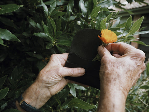 Patsy putting a marigold into the Dylan wallet