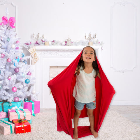 A girl is using a sensory swing as a sensory wrap.