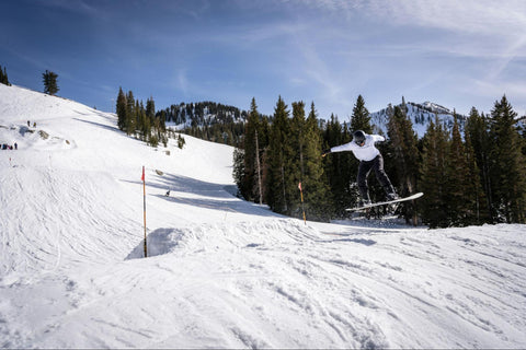 A person snowboarding on a snowy slope in Utah.