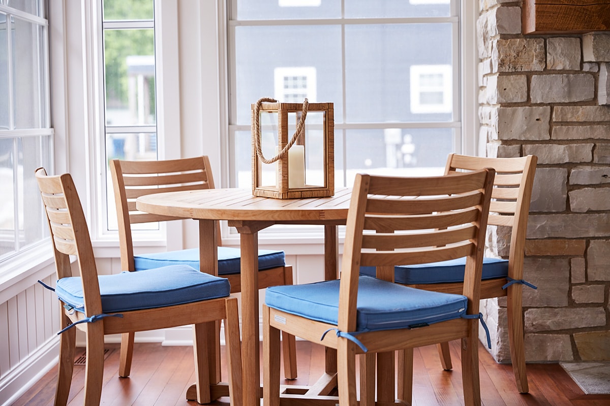 wood table and chairs with blue seat cushions