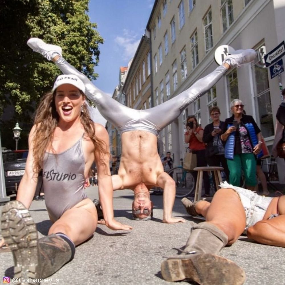 Flash mob dancing in street in silver mens leggings