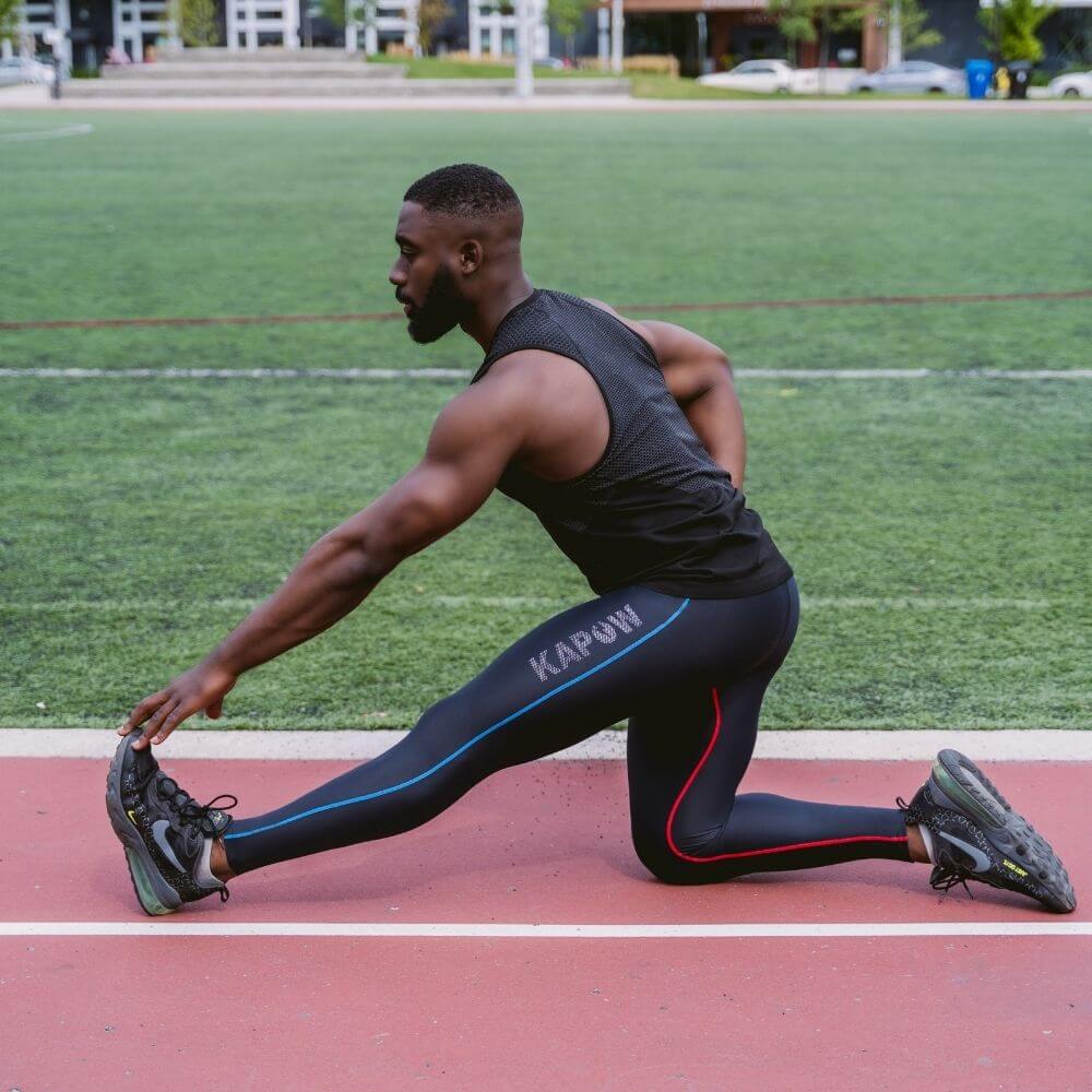 Man streching in track field