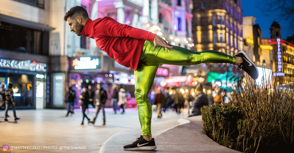 yoga pose man  wearing metallic green mens tights on street