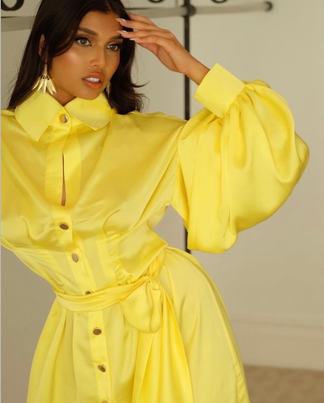 image of Shamaya shambizzle in yellow Khirzad dress and gold palm tree earrings 