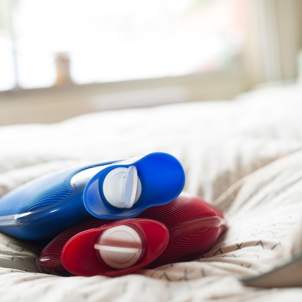 Hot water bottles on a bed